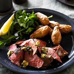 Grilled aussie flat iron steaks with anchovy and thyme butter